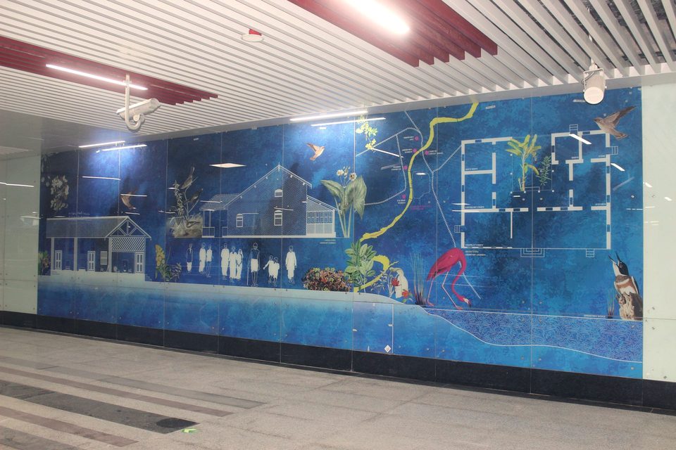 Large-format printed wall mural in a metro station concourse